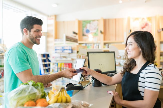 Man Making Payment Through Credit Card In Supermarket